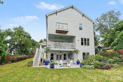 Rear view of the home with balacony, porch and patio areas