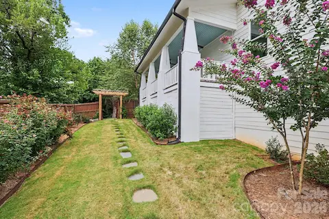 Side yard with view to gate and access to greenway