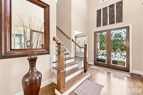 Gorgeous 2-story entry with custom glass and wrought iron doors.