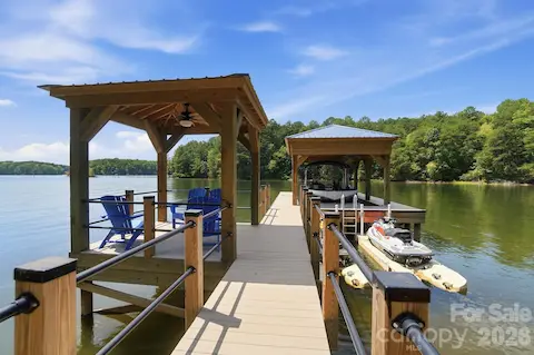 Stationary dock with covered boat lift, 2 personal watercraft docks, and covered sitting area