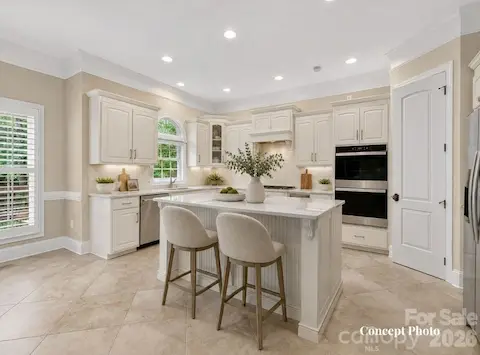 Concept photo virtually staged/upgraded photo of chef’s kitchen showcases rich custom cabinetry, granite countertops, stainless steel appliances, a large center island, and an open layout designed for effortless entertaining.