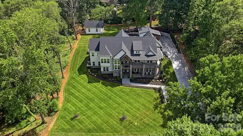 Aerial view showcasing the home and beautifully maintained grounds
