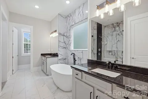 Primary bath with dual vanity and custom tiled shower
