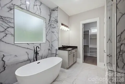 Spa-inspired primary bath with freestanding soaking tub