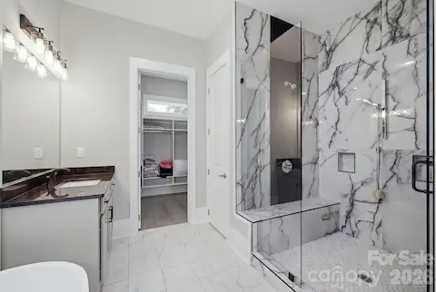 Primary bath featuring soaking tub and oversized tiled shower