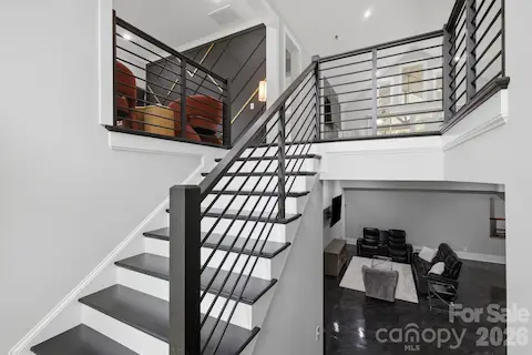 Modern staircase leading to the finished lower level