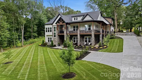 Impressive front exterior with expansive lawn.