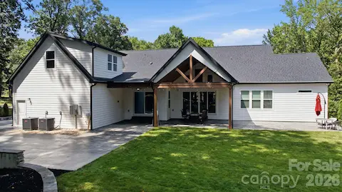 Rear elevation showcasing the home’s architecture and outdoor spaces