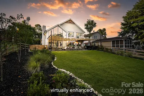 Custom floor to ceiling windows off great room. Grass virtually enhanced.