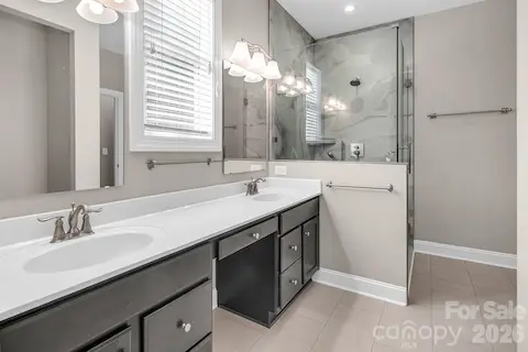 Primary Bathroom has dual vanities, large walk in shower and a huge walk in closet.