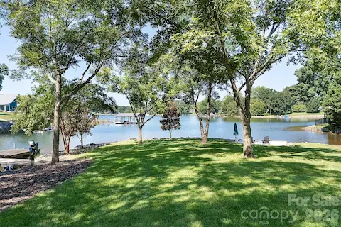 Lot features some trees, dock is off to the left and there is a beach pad on the right for up close waterviews and fun!