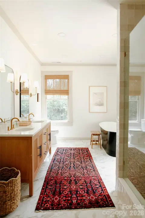 ensuite primary bathroom with stand alone soaker tub and walk in shower
