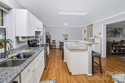 Updated kitchen with granite countertops, center island and white countertops
