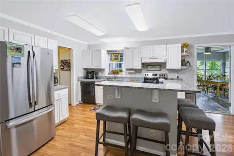 Updated kitchen with granite countertops, center island and white countertops