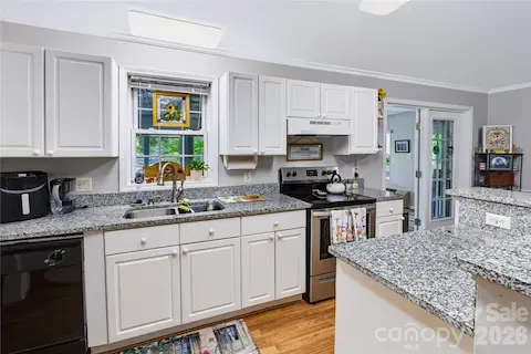 Updated kitchen with granite countertops, center island and white countertops