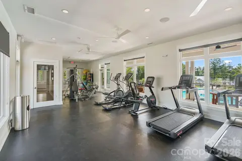 Community fitness room offers lake views while working out