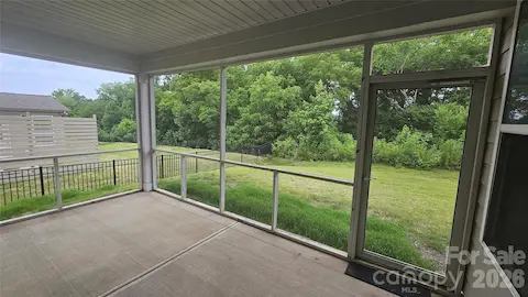 Beautiful screened in porch overlooking treed backyard