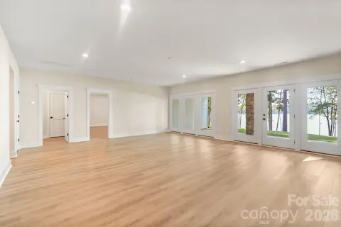 Fully finished walk-out lower level rec room leads to covered back patio