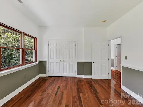 Spacious secondary bedroom offers Brazilian hardwood flooring, ample closet space, and abundant natural light.