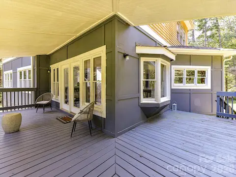 Expansive deck and covered outdoor living areas offer plenty of space for relaxing and entertaining while enjoying the surrounding natural setting.