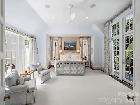 Primary suite on the main floor opens to putting green and courtyard.