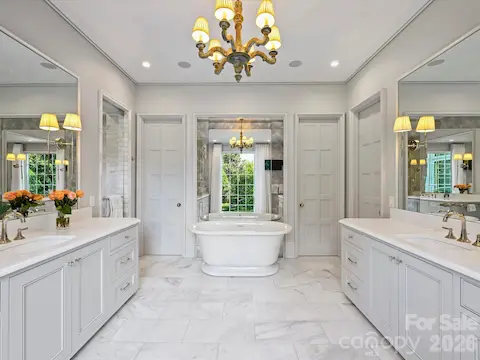 Primary bath has soaking tub, steam shower, dual vanities and dual water closets