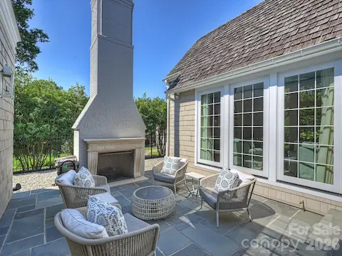 Side yard courtyard has wood-burning fireplace