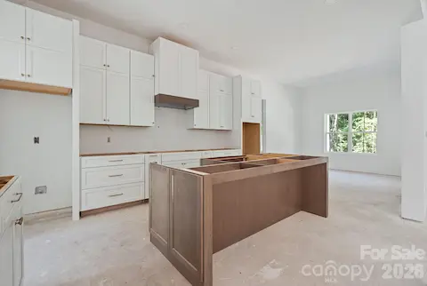 The heart of the home is a wonderful gathering space.  Lower drawers, shaker cabinets and quartz countertops complete this space.