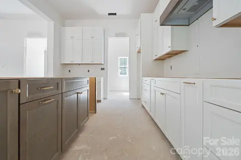 The two toned cabinetry has pretty hardware and soft close hinges.