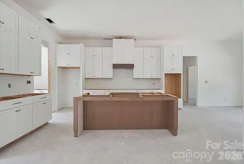 Wall oven/microwave, quartz counters, pretty tile backsplash.