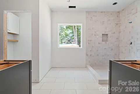 The private water closet has cabinetry for added storage.