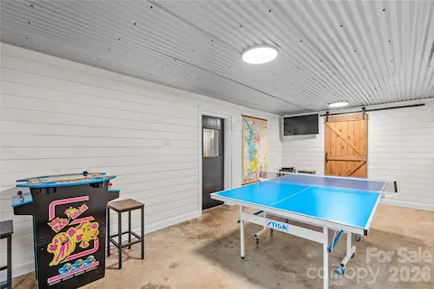 Recreation room with laundry room behind the barn door