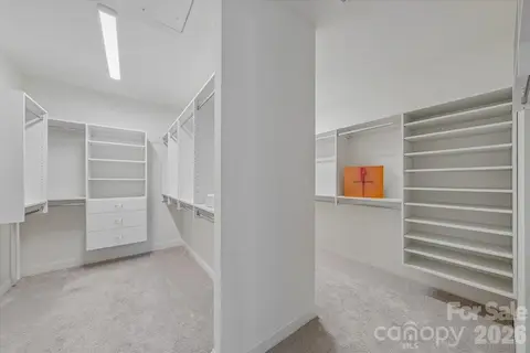 Primary Walk in Closet with Custom Built Ins