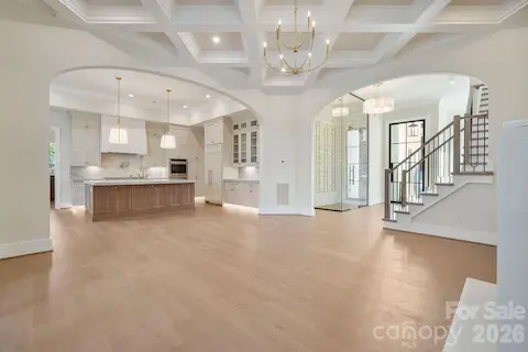 Beautifully framed archways connect the family room to the foyer and kitchen, adding architectural character while maintaining an open, flowing layout.