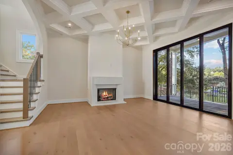 Custom limestone fireplace surround paired with a Venetian plaster feature wall, creating a sophisticated focal point in the family room.