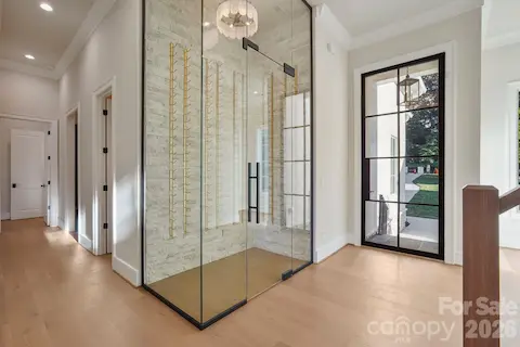 Elegant foyer featuring 7" white oak flooring and a thoughtfully concealed powder room, providing added privacy while maintaining a clean, sophisticated entry.