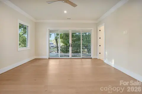 Spacious primary bedroom featuring 10' ceilings and a bright, open feel, creating a comfortable and refined private retreat.