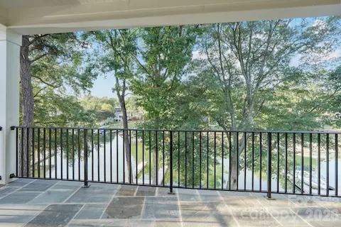 Private primary suite balcony creates an intimate outdoor retreat with beautiful water views and a peaceful setting to enjoy the lake.