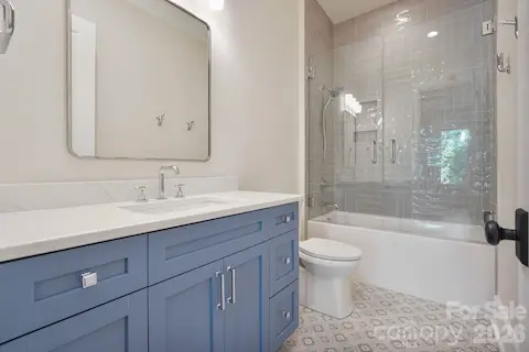 Beautifully finished upstairs shared bath featuring a full-size tub with a custom tile surround and elevated finishes throughout.