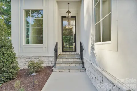 Welcoming front porch featuring timeless flagstone steps, adding natural texture and an elevated finish to the home’s grand entrance.