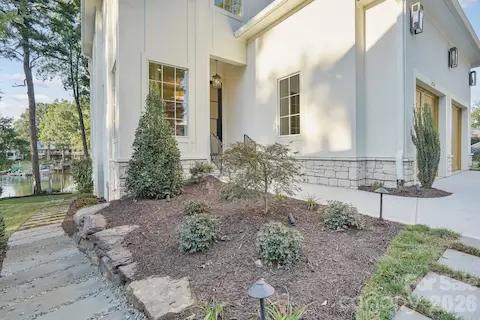 Professionally designed luxury landscaping enhanced by architectural night lighting, beautifully highlighting the home and grounds after sunset