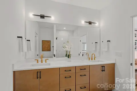 Primary Bathroom w/ dual vanities and custom walk-in closet