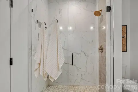 Primary Bathroom w/ dual vanities and custom walk-in closet