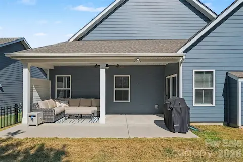 Huge covered back porch with privacy wall