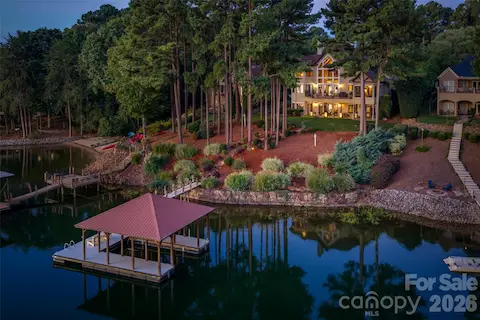 Private covered dock with boat lift, protected deep-water access and waterfront verandas