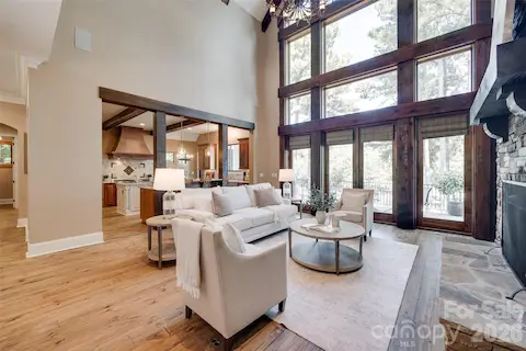 Great room with custom timber detailing and a dramatic wall of lake-facing windows