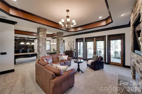 Lower level living area with stone fire place and French doors to the lower veranda