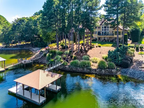 SPrivate covered dock with boat lift and a landscaped shoreline along a protected deep-water cove