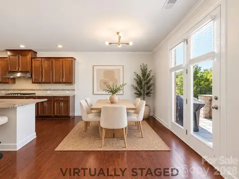Virtually staged, the breakfast area offers a bright everyday dining space beside the kitchen, with direct access to the backyard.