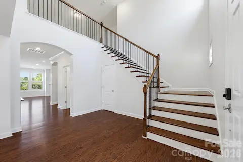 The open foyer and staircase set a gracious tone, with sightlines that make the main level feel connected and welcoming.